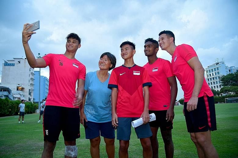 While more than 20,000 fans were at the National Stadium for Brazil's friendly against Nigeria on Sunday, two Singaporeans were at the Geylang Lorong 12 field to watch the Lions prepare for today's World Cup qualifier against Uzbekistan. Royce Yap (i