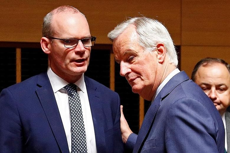 Irish Foreign Minister Simon Coveney (left) with the European Union's chief Brexit negotiator Michel Barnier in Luxembourg yesterday. Britain's proposals are shrouded in secrecy but the focus is on Northern Ireland's relationship to the EU's Customs 
