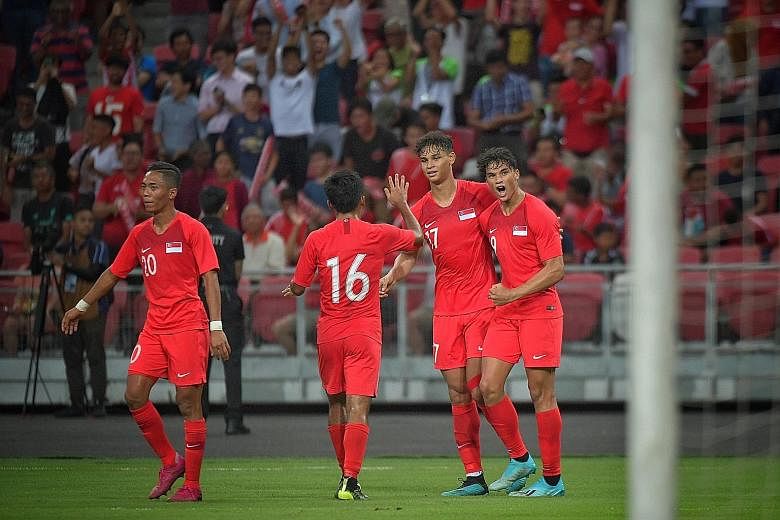 Left: Uzbekistan's Eldor Shomurodov, their two-goal hero, missing an open goal after rounding Singapore goalkeeper Izwan Mahbud in the second half of their World Cup Asian Zone Group D qualifier. Singapore had gone into the break with the game poised