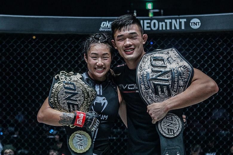 Angela Lee and her brother Christian posing with their belts after both won their bouts at the One: Century event in Tokyo on Sunday. Angela is ranked 14th on ESPN's top 25 MMA fighters under 25 list, while Christian is 22nd. PHOTO: ONE CHAMPIONSHIP