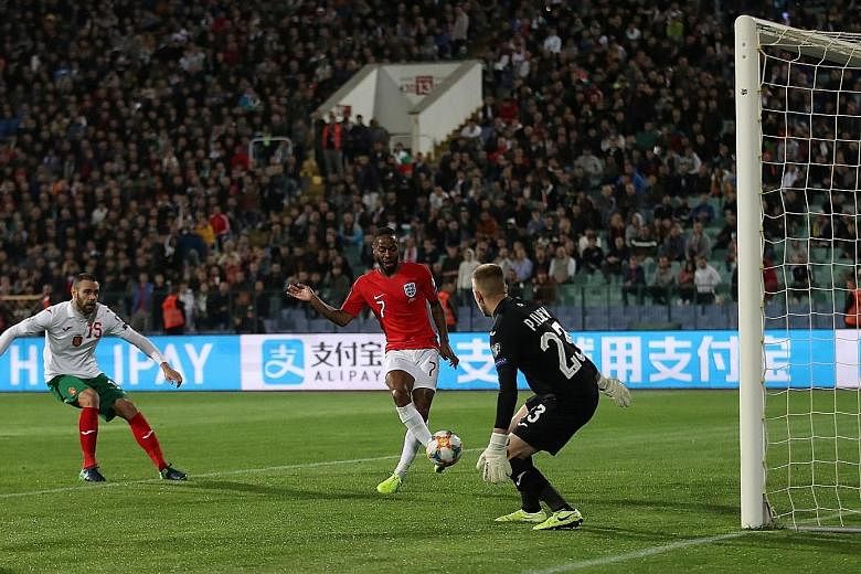 England's Raheem Sterling, one of the players targeted by racial abuse, scoring his team's fourth goal in the 6-0 Euro 2020 qualifying win over Bulgaria on Monday night.