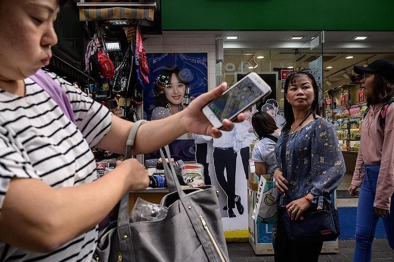 Shoppers in the Myeongdong district of Seoul last month. Recent data has continued to paint a gloomy picture of South Korea's economy, especially with consumer prices falling.