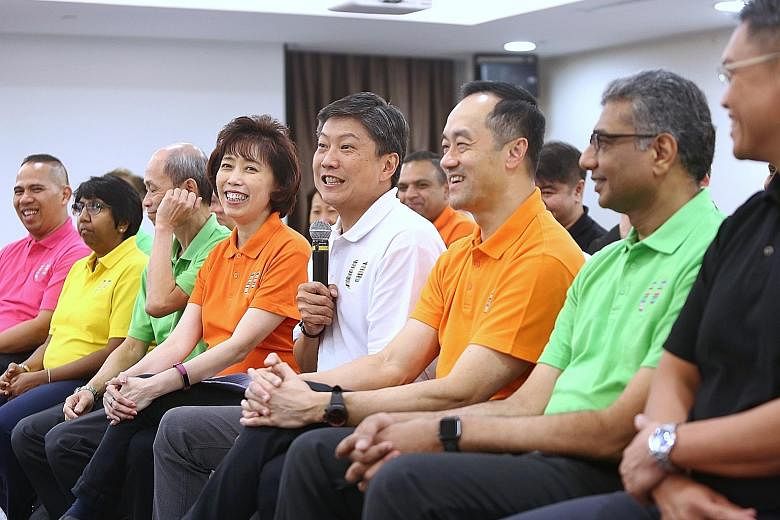 NTUC secretary-general Ng Chee Meng (in white) at a media briefing yesterday with the new NTUC central committee members. They are (from left) vice-presidents Abdul Samad Abdul Wahab, K. Thanaletchimi and Ong Hwee Liang; president Mary Liew; deputy s