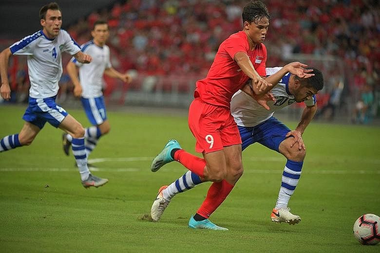 Ikhsan Fandi, who scored in the 3-1 loss to Uzbekistan, challenging for the ball during the World Cup 2022 qualifier at the National Stadium on Tuesday. Singapore, fourth in Group D with four points, will have to finish top or among the four best run