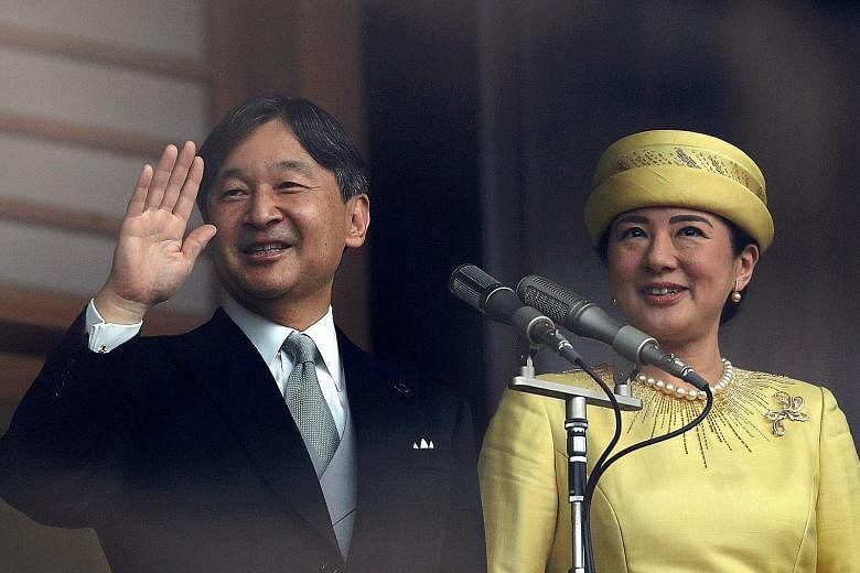 Japan's Emperor Naruhito and Empress Masako greeting well-wishers during their first public appearance at the Imperial Palace in Tokyo in May. PHOTO: REUTERS