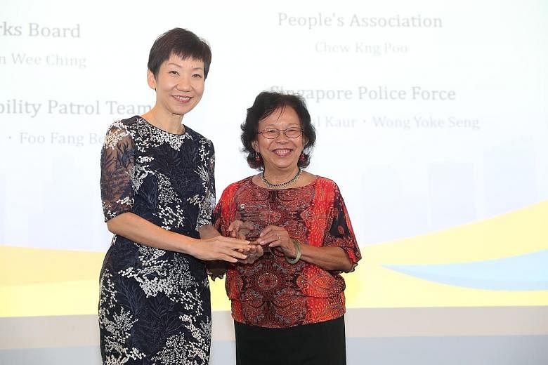 Ms Eileen Chan, chairman of the Nee Soon Central Active Mobility Patrol team, receiving an award in the community category on behalf of her team from Minister for Culture, Community and Youth Grace Fu at the Municipal Services Awards event yesterday.