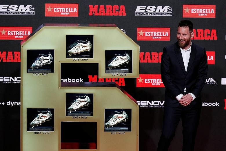 Barcelona's proud captain Lionel Messi showing off his six Golden Shoe prizes, one each for scoring the most goals in a European domestic league season. PHOTO: REUTERS