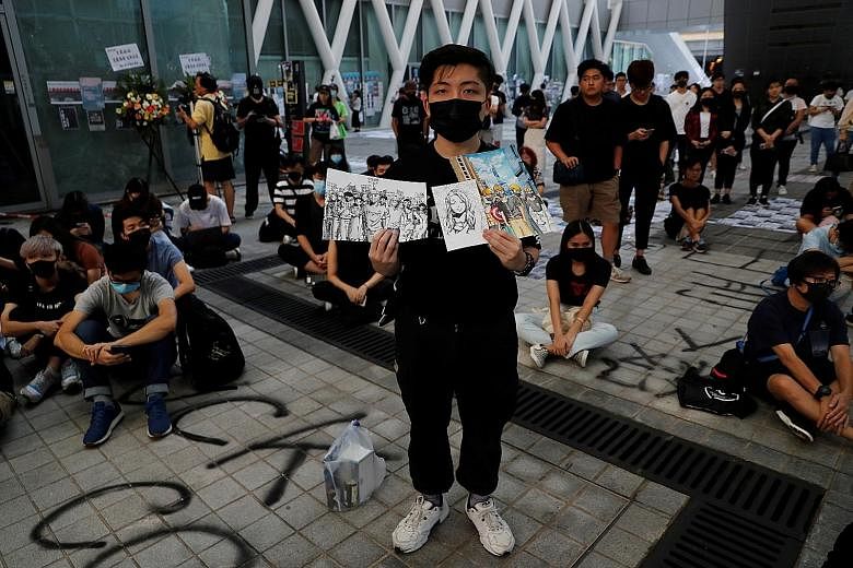 An anti-government protester making a stand with drawings during a Hong Kong demonstration yesterday. PHOTO: REUTERS