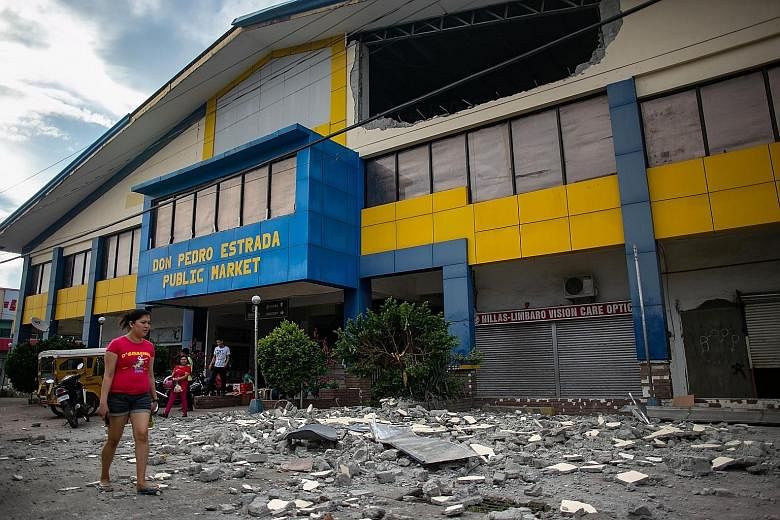 Debris from a partially damaged building in the city of Digos in Davao del Sur province on the southern Philippine island of Mindanao yesterday, after a 6.4-magnitude earthquake struck the Mindanao region on Wednesday night. The authorities said five