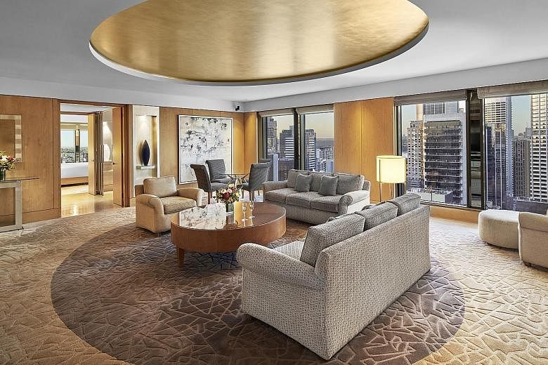 Sleek designs and luxurious suites (above) are part of The Fullerton Hotel Sydney, which also has a grand staircase.