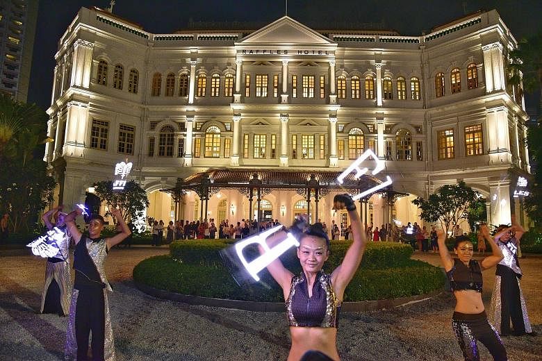 Above: Dancers performing outside Raffles Hotel as part its official unveiling last night. Right: Kit Chan singing at The Lawn of Raffles Hotel. Others who provided live entertainment included indie-pop band The Sam Willows, singer and songwriter Inc