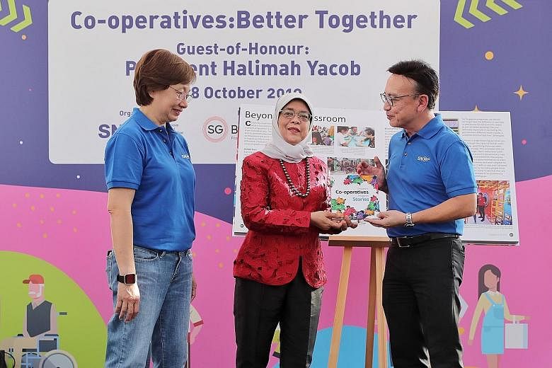 President Halimah Yacob with Singapore National Co-operative Federation (SNCF) chief executive Dolly Goh and SNCF chairman and NTUC LearningHub chief executive Kwek Kok Kwong at the launch of the book, Singapore Co-operatives, Singapore Stories, at t