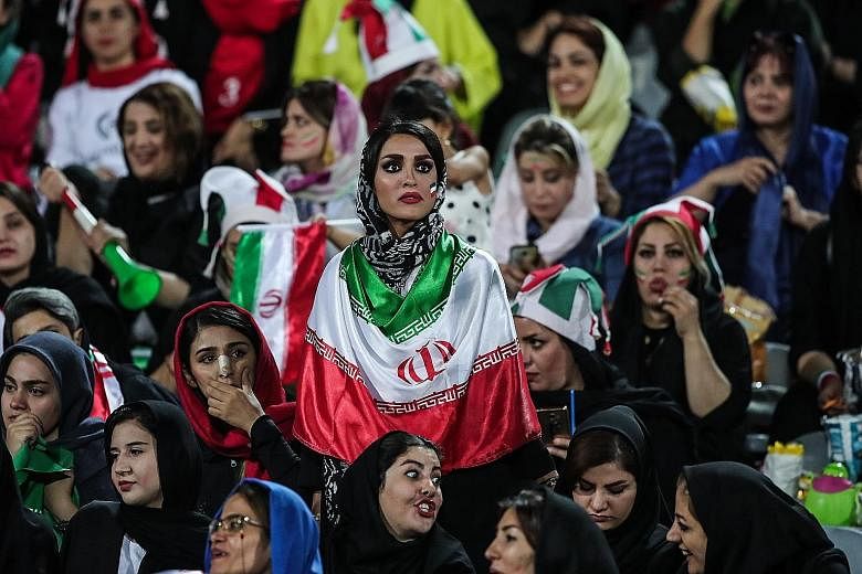 Iranian women attending the World Cup 2022 qualifier between Iran and Cambodia at the Azadi Stadium in Teheran on Oct 10. For the first time since the 1979 Islamic Revolution, women were allowed to attend a football match.