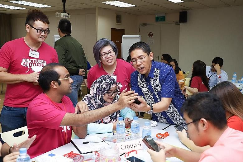 Senior Minister of State for Defence and Foreign Affairs Maliki Osman, interfaith adviser to the Buddhist Youth Network (BYN), at a workshop for the Singapore Action for Youth Interfaith Movement last year. BYN director Yap Ching Wi says Buddhists ma