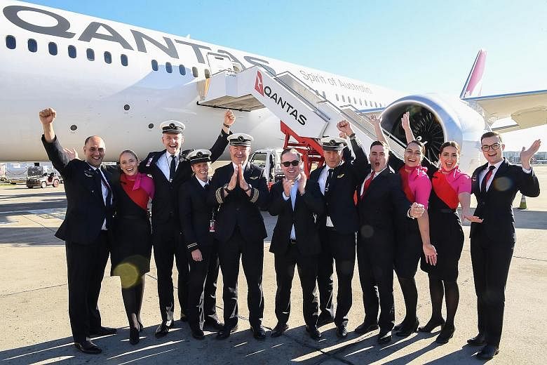 Qantas Group CEO Alan Joyce (centre) and crew celebrating in front of a Qantas Boeing 787-9 Dreamliner after arriving in Sydney yesterday morning, having completed a non-stop test flight from New York. It took 19 hours and 16 minutes. PHOTO: AGENCE F