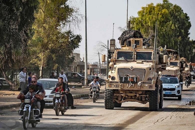 US military vehicles in Tal Tamr yesterday after pulling out from their base. Turkey's President Recep Tayyip Erdogan agreed last Thursday in talks with US Vice-President Mike Pence to a five-day pause in the offensive to allow time for Kurdish fight