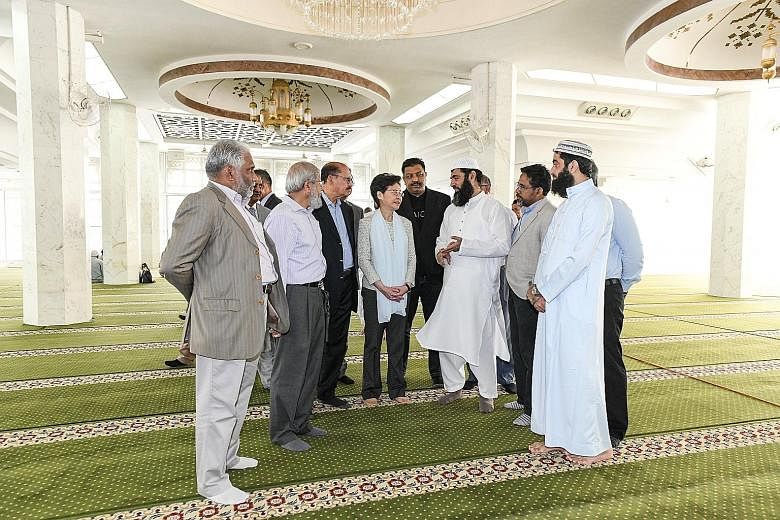 Hong Kong Chief Executive Carrie Lam visiting the mosque in Tsim Sha Tsui yesterday to meet members of the Islamic Trust, a community group. She apologised for the inadvertent spraying of the mosque's main entrance and gate with coloured water during