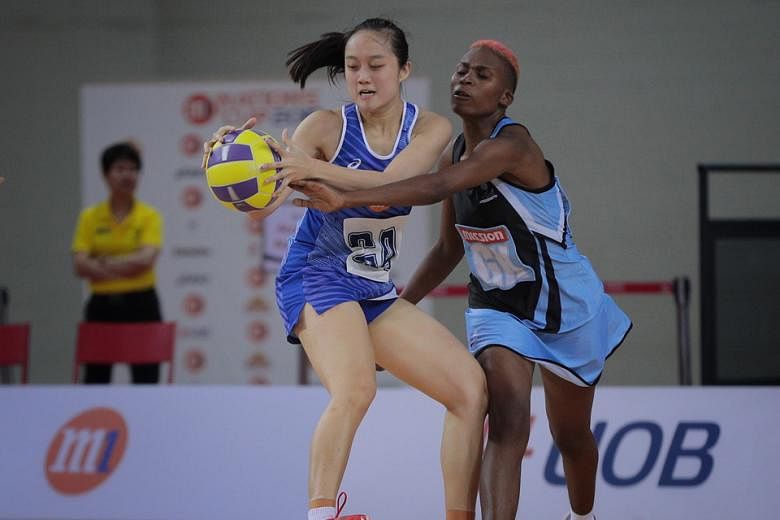 Singapore's Toh Kai Wei trying to shake off her Botswana marker during their match yesterday. ST PHOTO: JASON QUAH
