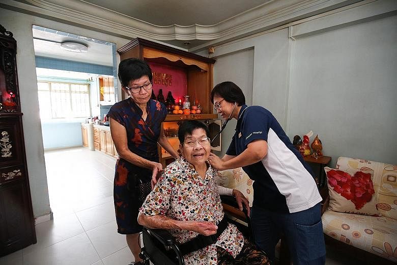 Ms Madeline Tan (far left), 63, gets help to manage her 86-year-old mother's chronic conditions under the "Integrated General Hospital" pilot care model. She regularly sends Madam Soh Lai Hong's blood pressure and diabetes readings to Alexandra Hospi