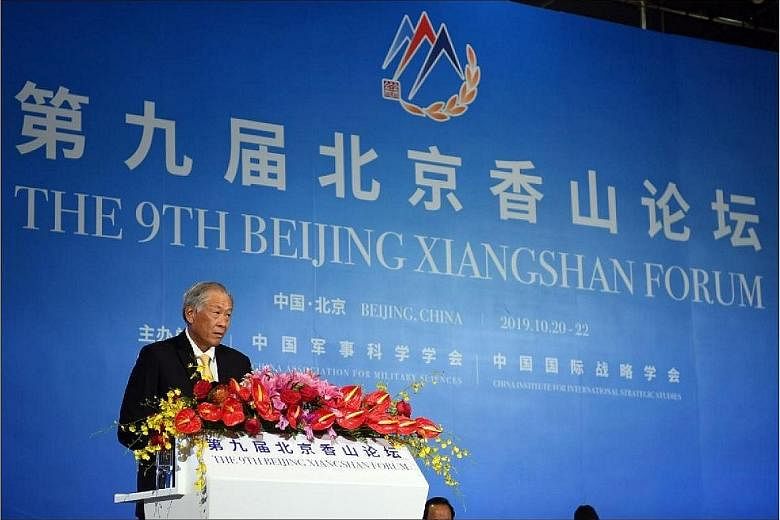 Defence Minister Ng Eng Hen speaking at a plenary session on the interests of small and medium-sized states at the Beijing Xiangshan Forum yesterday. He said the world needs both the US and China to work together to ensure progress and stability, and