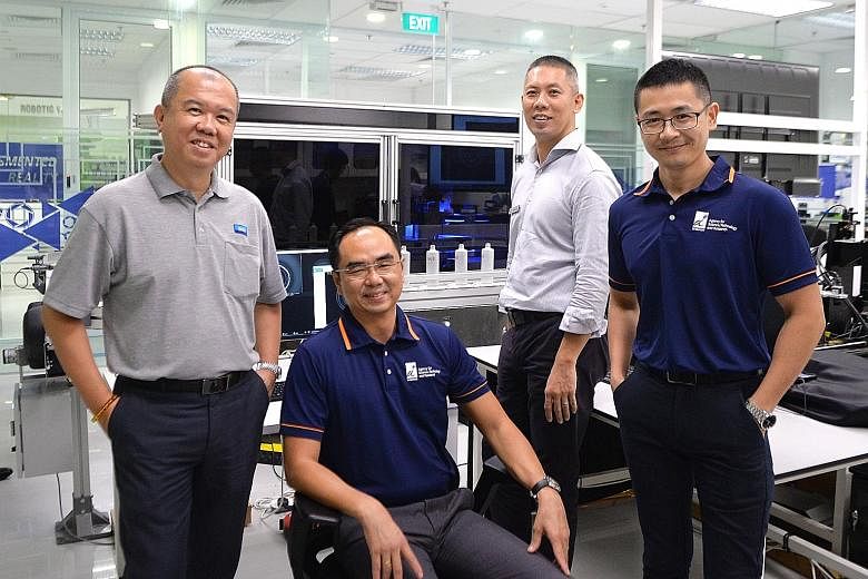 The creators of the automated inspection system for SK-II bottles include (from left) M8M co-founder and director Chua Choon Beng, ARTC chief executive David Low, JM Vistec System managing director Eugene Goh and ARTC group manager of intelligent pro