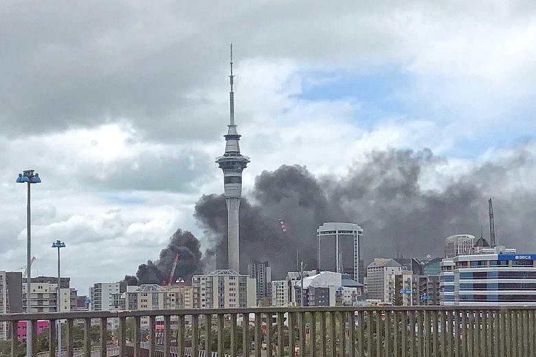 Thick smoke billowing out of the SkyCity Convention Centre in Auckland yesterday. The building, which is under construction, is estimated to be the biggest construction project currently under way in New Zealand. PHOTO: AGENCE FRANCE-PRESSE