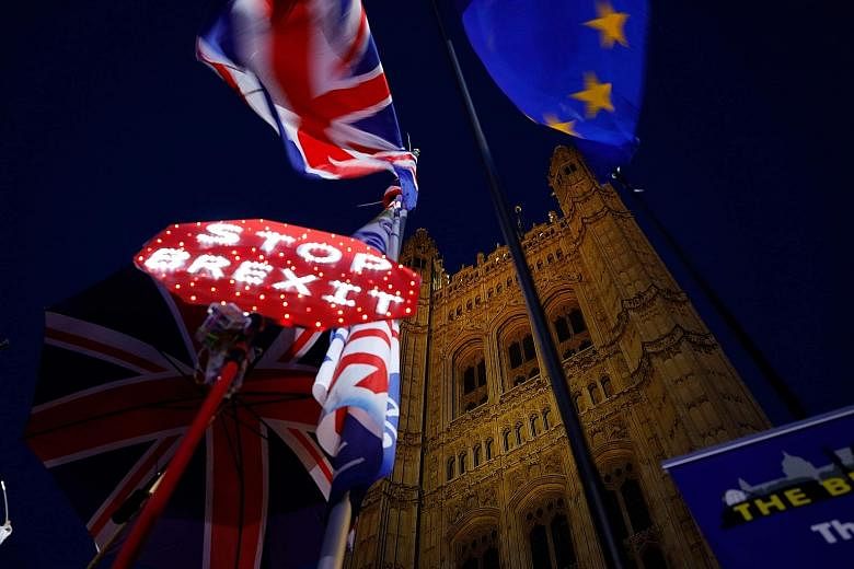 Banners, the Union Jack and EU flag outside the Houses of Parliament in London on Tuesday, as MPs debated the second reading of the British government's European Union Withdrawal Agreement Bill.