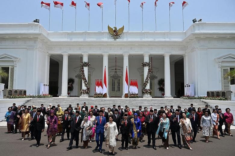 Indonesian President Joko Widodo and his wife Iriana Widodo (in front, centre) with his ministers and their spouses at Merdeka Palace in Jakarta yesterday.