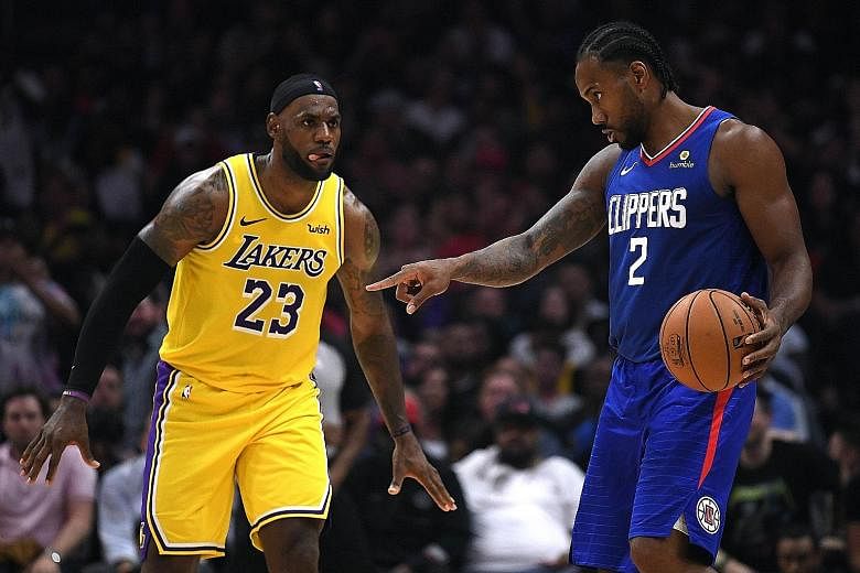 LA Clippers' Kawhi Leonard (right) controlling the ball as LeBron James of the LA Lakers approaches during their NBA game in Los Angeles on Tuesday. The Clippers, with Lou Williams saying they wanted to debunk the notion that they are the 'little bro