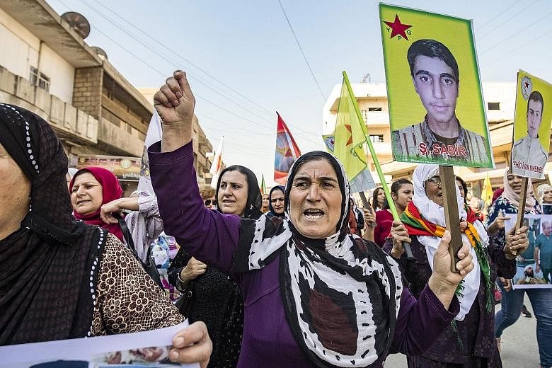 Syrian Kurds protesting against the Turkish assault on north-eastern Syria, yesterday. Kurdish forces, which held close to a third of Syria two weeks ago, have now lost almost everything, after a deal struck between Moscow and Ankara on Tuesday.