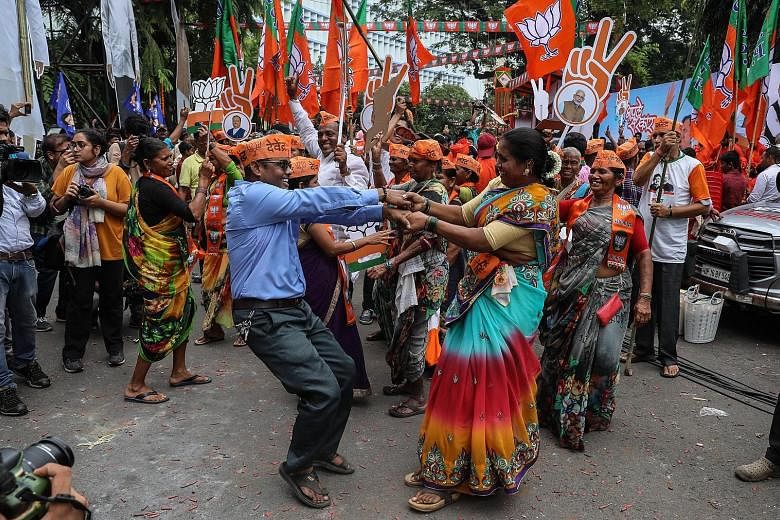 India's Bharatiya Janata Party (BJP) supporters celebrating their lead in the Maharashtra state election, outside BJP's head office in Mumbai yesterday. PHOTO: EPA-EFE