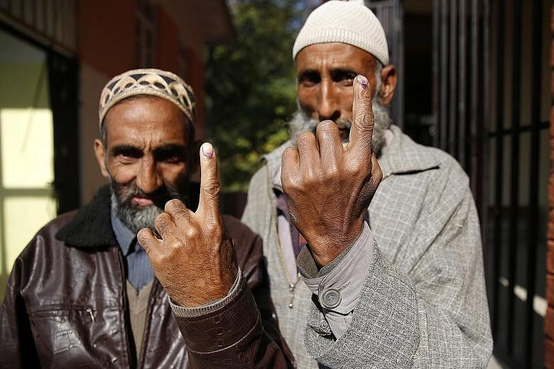 Village heads showing the indelible ink on their fingers after casting their votes in the first-ever Block Development Council polls in Chek Dara on the outskirts of Srinagar yesterday.