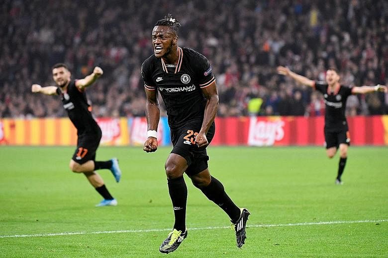Chelsea forward Michy Batshuayi celebrating after scoring the 86th-minute winner in Chelsea's 1-0 defeat of Ajax in the Champions League in Amsterdam on Wednesday. It was Chelsea's second straight Group H win. PHOTO: REUTERS