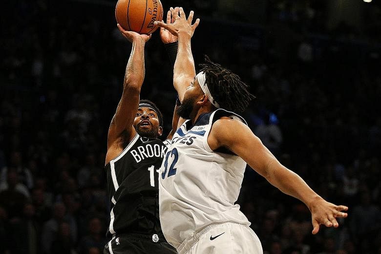 Minnesota Timberwolves centre Karl-Anthony Towns attempting to block a shot by Brooklyn Nets guard Kyrie Irving during their NBA game at the Barclays Centre on Wednesday. Despite Irving's 50 points, Minnesota won the contest 127-126 in overtime. PHOT