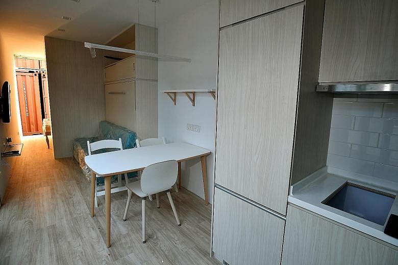 Entrepreneur Seah Liang Chiang (right) dreams of having 50 container hotels spread across 20 locations islandwide. The containers are equipped with a toilet, kitchen and dining area (above), TV, sofa, and a bedroom with a queen-size bed (below). ST P