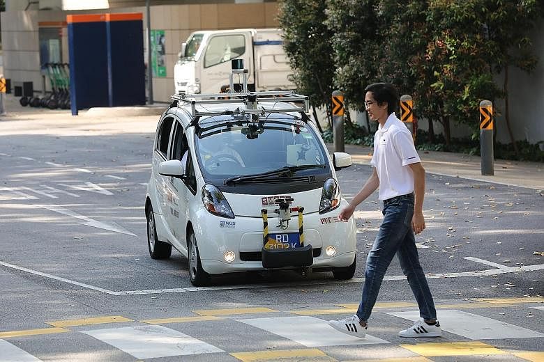 A self-driving electric vehicle being tested on the road in University Town at the National University of Singapore. All autonomous vehicles will have to display prominent decals and have markings to ensure easy identification by other road users. ST