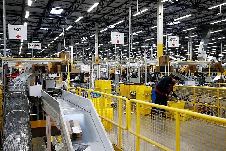 An Amazon fulfilment centre in Kent, Washington. Amazon's fourth-quarter cost for one-day shipping will be nearly double the US$800 million the company spent during the second quarter, chief financial officer Brian Olsavsky said.