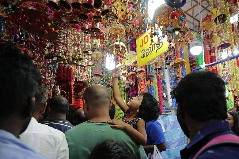 As the streets of Little India glowed with lights, families did their last-minute shopping for colourful decorations, traditional wear and festive treats yesterday evening at the many stalls of the Deepavali Festival Village in Campbell Lane. The ann