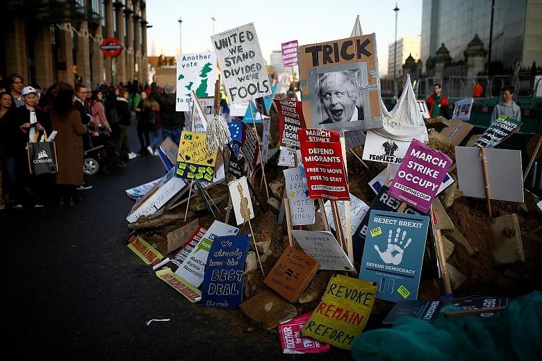 Rally placards outside the Houses of Parliament in London. The British government yesterday denied a newspaper report that it will seek to weaken workers' rights after the country leaves the EU. PHOTO: REUTERS