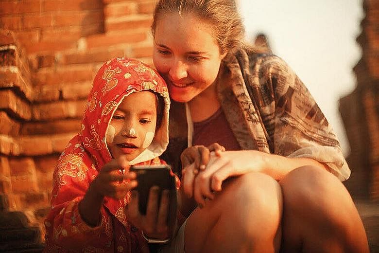 Ms Katrin Nagel (above, with a child in Myanmar) on her experience with meeting fellow solo women travellers on her trips
