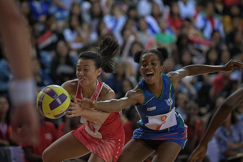Singapore's Carmen Goh challenged by Namibia's Anna Shipanga for the ball during the M1 Nations Cup final yesterday. Singapore gave up a half-time lead in the seven-goal loss.