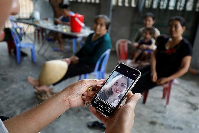 A relative in Vietnam looking at an image of Ms Bui Thi Nhung, 19, one of those feared to be among the 39 people found dead in a truck container near London. Vietnam's Prime Minister Nguyen Xuan Phuc yesterday ordered an investigation into human traf