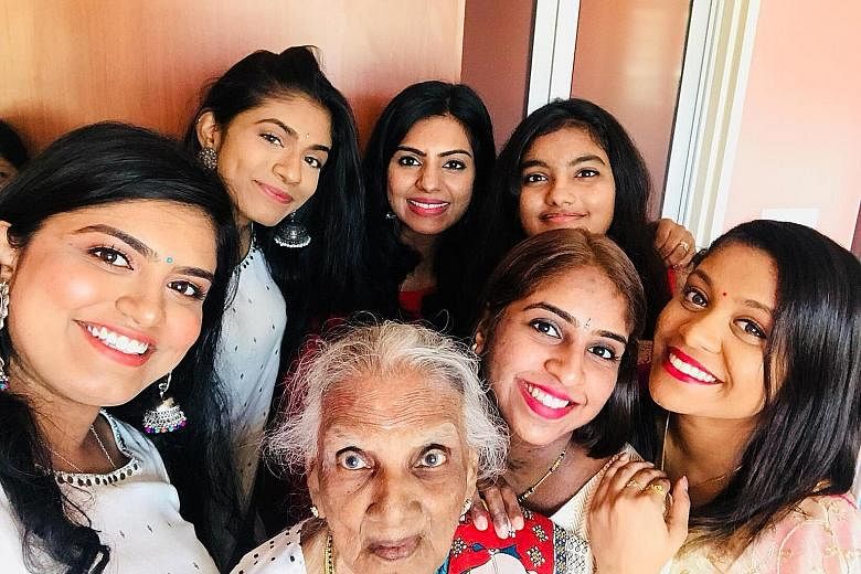 Madam Nadeson Pillai Muthulaxmy with her granddaughters (clockwise from left) Gangaa, Yamunaa, Radha, Tia, Divya and Karthiga at the Deepavali gathering at her flat in Henderson Road yesterday.