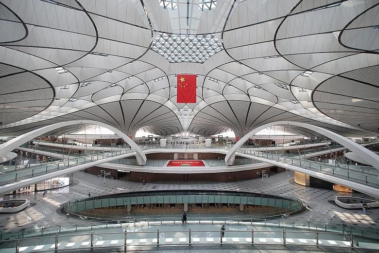 Beijing's new US$63 billion (S$86 billion) Daxing airport began its first scheduled international flights yesterday as it ramped up operations to help relieve pressure on the city's existing Capital airport. Shaped like a phoenix - though to some obs