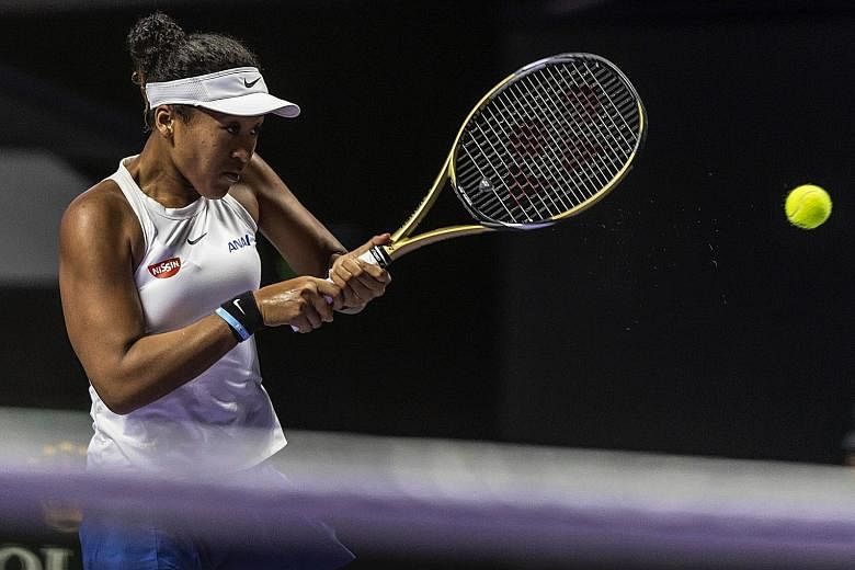 Naomi Osaka returning to Petra Kvitova in the opening match of the WTA Finals in Shenzhen. After recent titles in Osaka and Beijing, the in-form Japanese stretched her winning run to 11 matches with a three-set victory. 