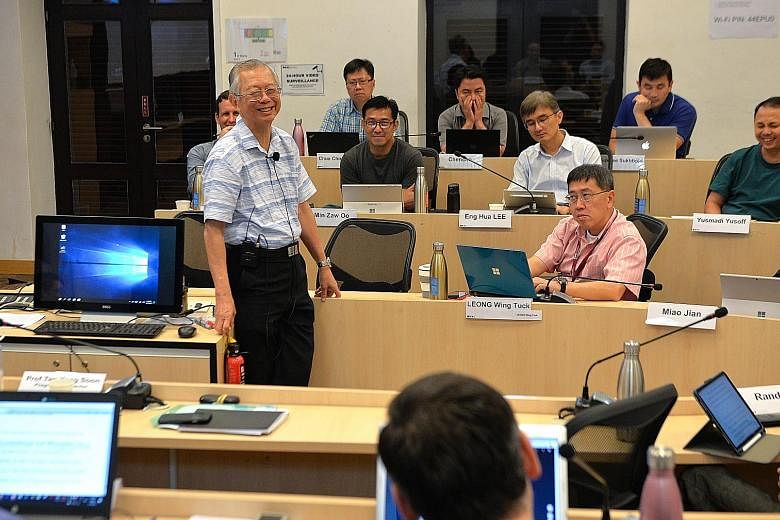 Lee Kuan Yew School of Public Policy professor Lim Siong Guan, former head of the civil service, in a discussion with participants of the Lee Kuan Yew Senior Fellowship in Public Service Programme.