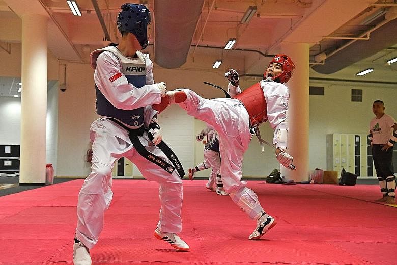 National taekwondo exponents Yap Teng Chung (left) and Raja Zulfadli Raja Mahmod training at the OCBC Arena. A major Games preparation committee is overseeing training for the SEA Games in the wake of the Singapore Taekwondo Federation's suspension. 