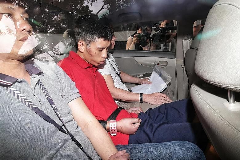 Gabriel Lien Goh arriving at the State Courts yesterday. Cuts and bruises could be seen on his face and arms, and his knuckles were swollen and red. He will be warded for psychiatric observation for three weeks. ST PHOTO: KEVIN LIM
