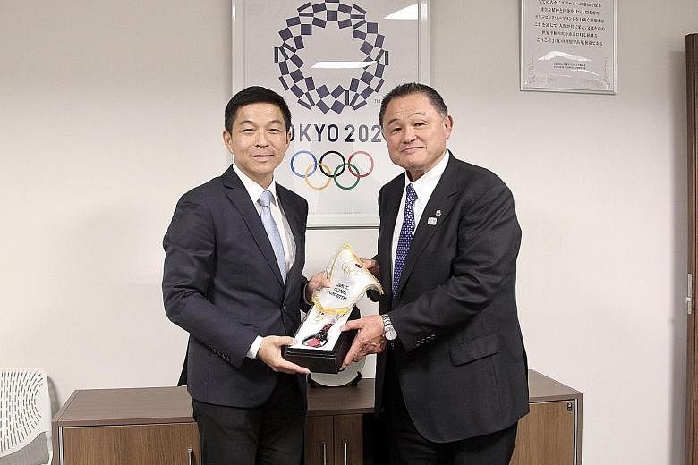 Mr Tan Chuan-Jin, president of the Singapore National Olympic Council, receiving a memento from Yasuhiro Yamashita, president of the Japanese Olympic Committee and Olympic judo open champion at Los Angeles 1984. The Speaker of Parliament led a delega