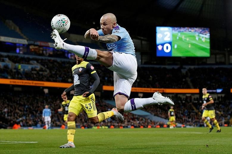 City's Spanish defender Angelino stretching for the ball against Southampton in their League Cup last-16 tie at the Etihad Stadium on Tuesday. While the Saints lost 3-1, it was a vast improvement from their 9-0 drubbing by Leicester in the league las